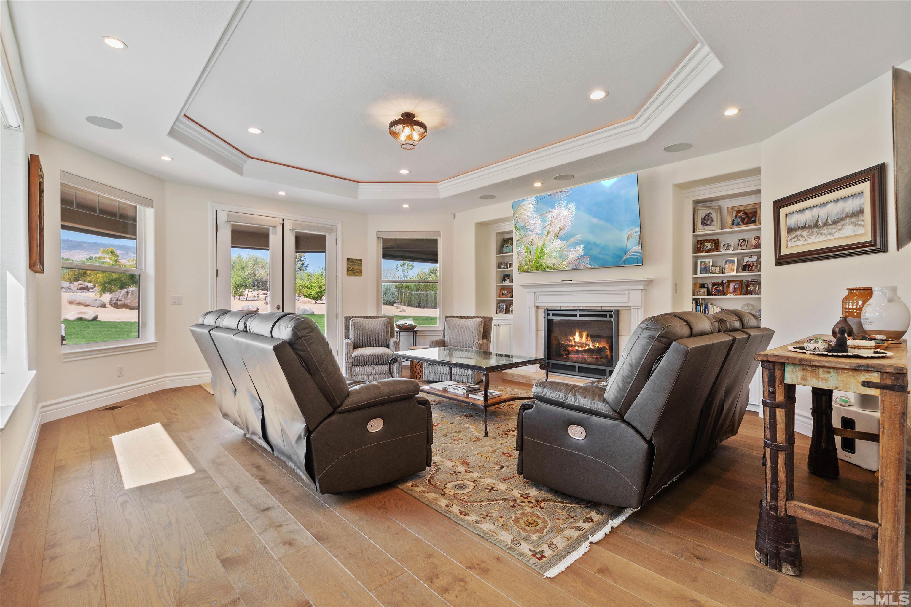 12825 Silver Wolf Road Reno, NV 89511 - Photo 18 of 34 a living room with furniture a large window and a fireplace