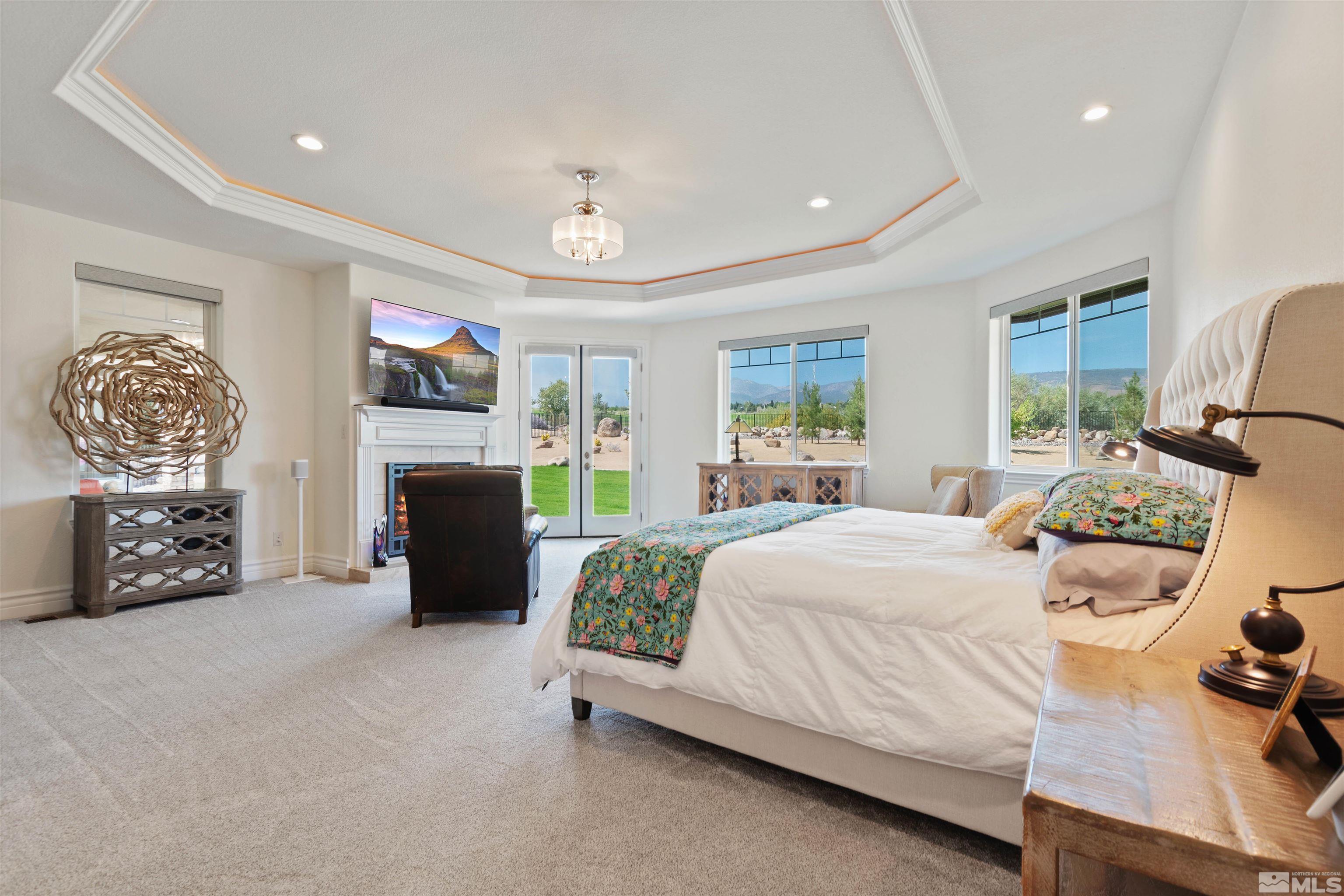 12825 Silver Wolf Road Reno, NV 89511 - Photo 21 of 34 a bedroom with a bed and a fireplace