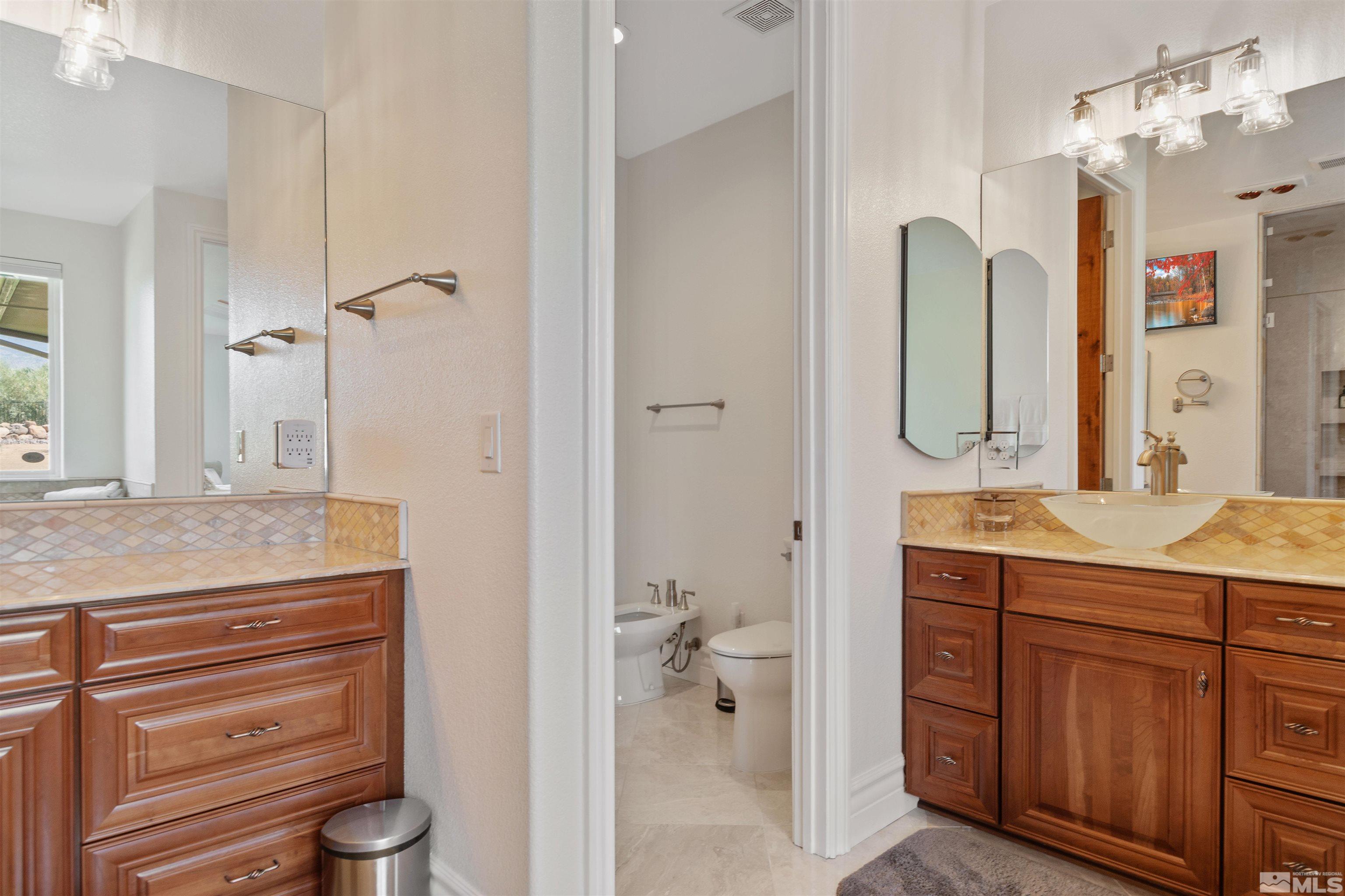 12825 Silver Wolf Road Reno, NV 89511 - Photo 25 of 34 a bathroom with a granite countertop sink and a mirror
