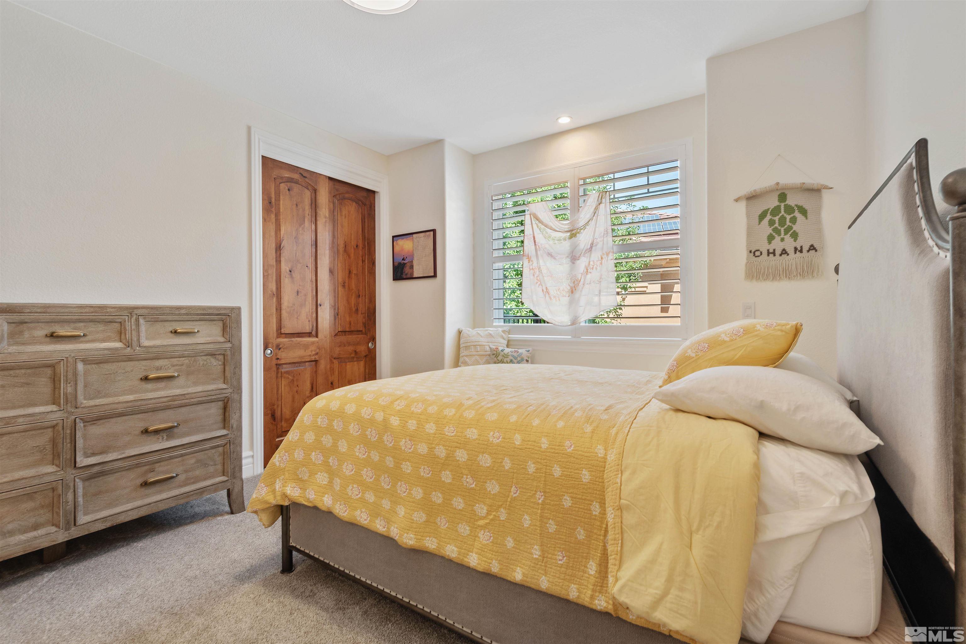 12825 Silver Wolf Road Reno, NV 89511 - Photo 26 of 34 a bedroom with a bed and a window