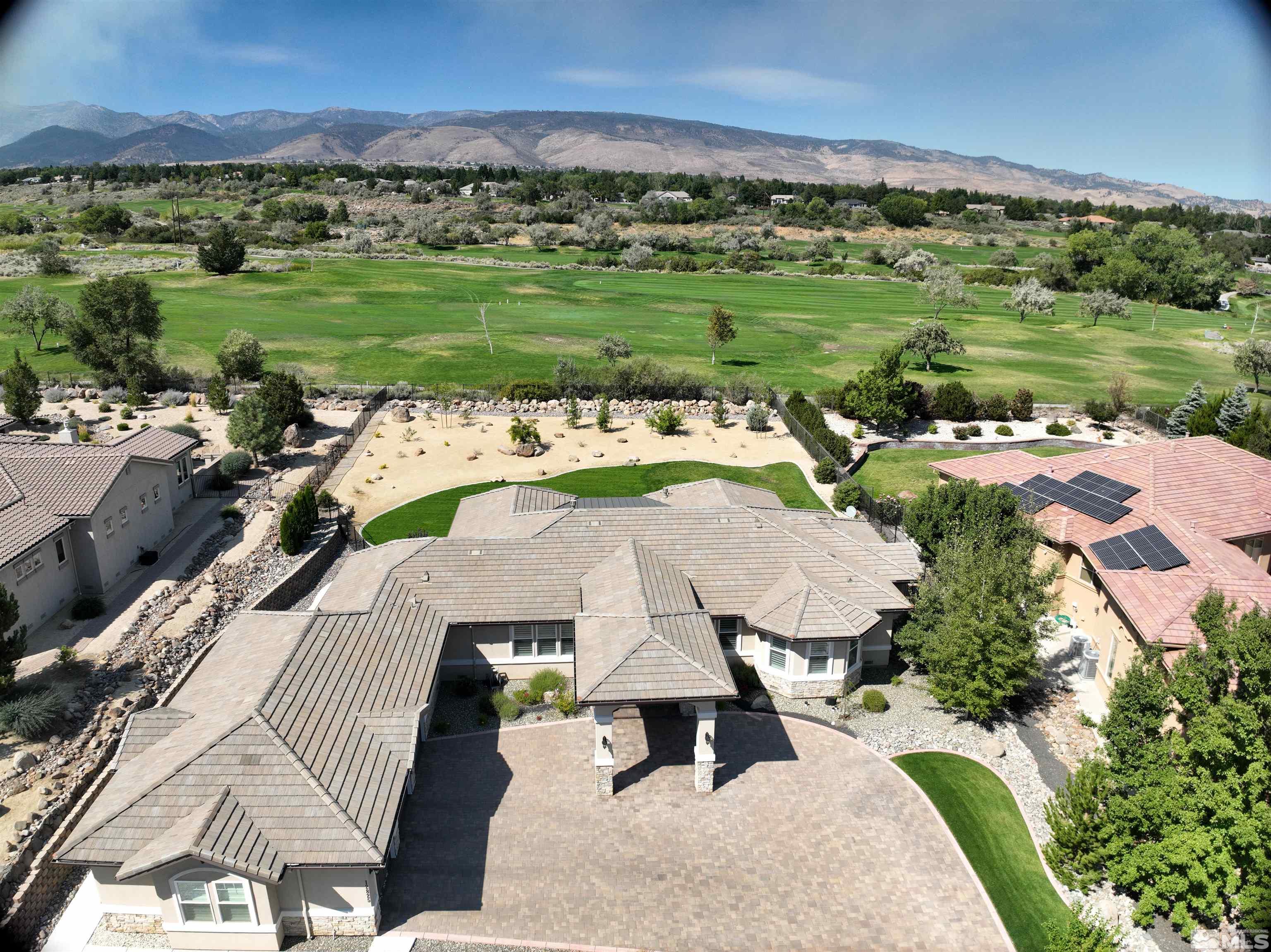 12825 Silver Wolf Road Reno, NV 89511 - Photo 3 of 34 an aerial view of a house with a garden and lake view