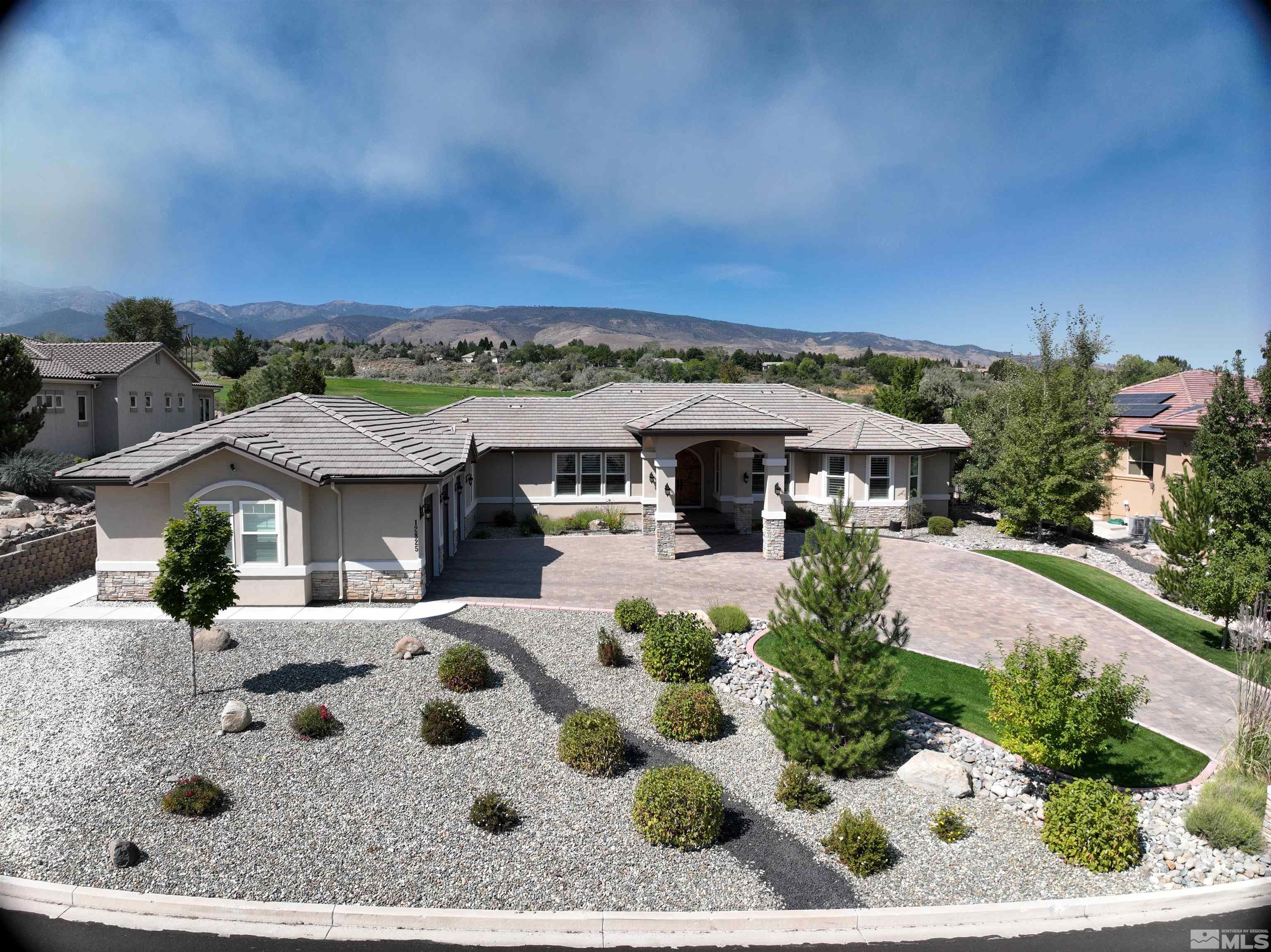 12825 Silver Wolf Road Reno, NV 89511 - Photo 33 of 34 a view of a white house with a yard
