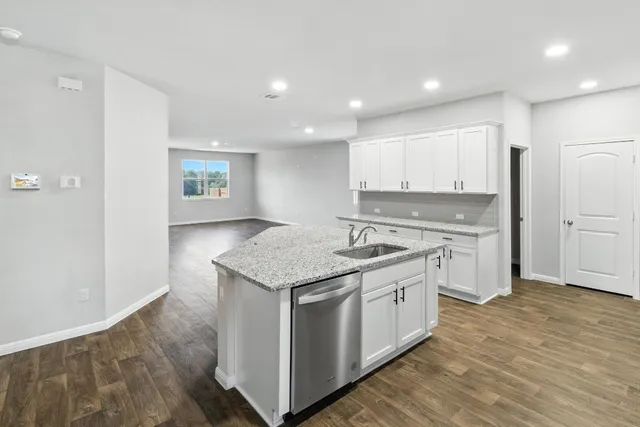 a kitchen with stainless steel appliances granite countertop a stove and a refrigerator