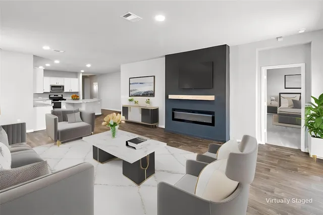 a living room with furniture and a flat screen tv