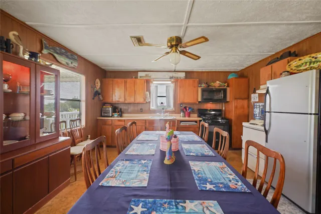 a large kitchen with stainless steel appliances granite countertop lots of counter top space and wooden floor