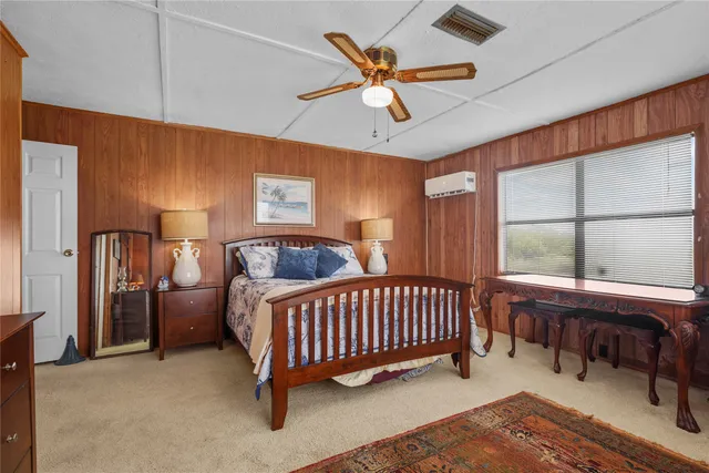 a room with furniture ceiling fan and a window