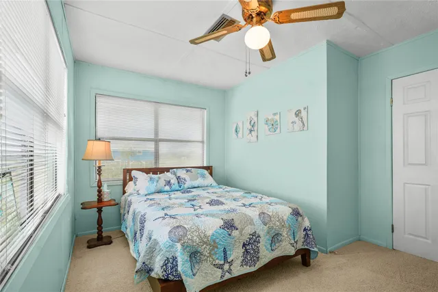 a bed sitting in a bedroom next to a window