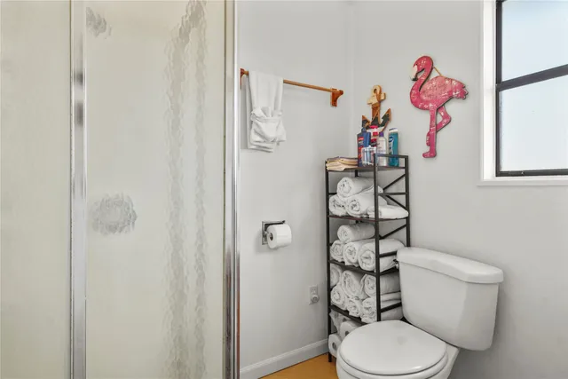 a bathroom with a toilet sink and shower curtain