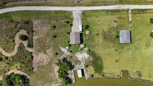 an aerial view of a residential houses with outdoor space