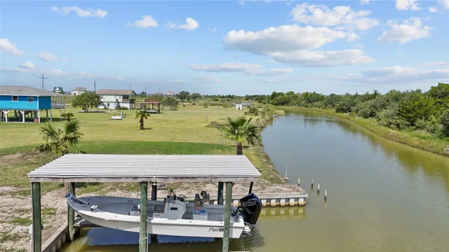 a view of a lake with a table and chairs
