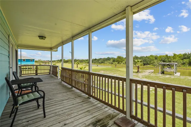 a view of a city from a balcony with furniture