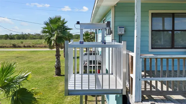 a view of a porch with a floor to ceiling window and yard