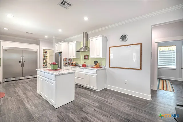a view of kitchen with furniture and wooden floor