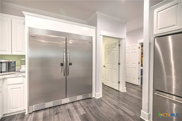 a kitchen with granite countertop a sink cabinets and window