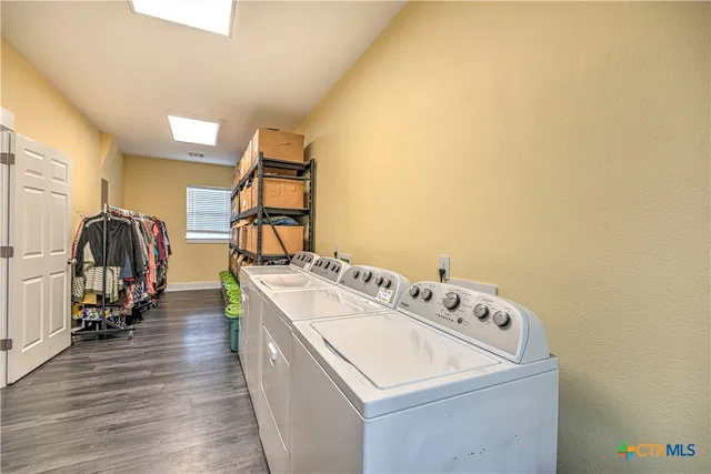 a view of a workspace with furniture and wooden floor