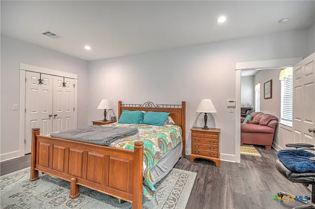 a bathroom with a granite countertop toilet sink and mirror