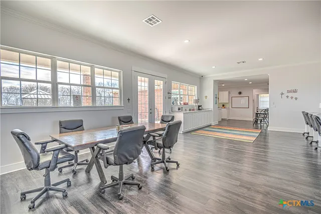 a large white kitchen with sink and cabinets