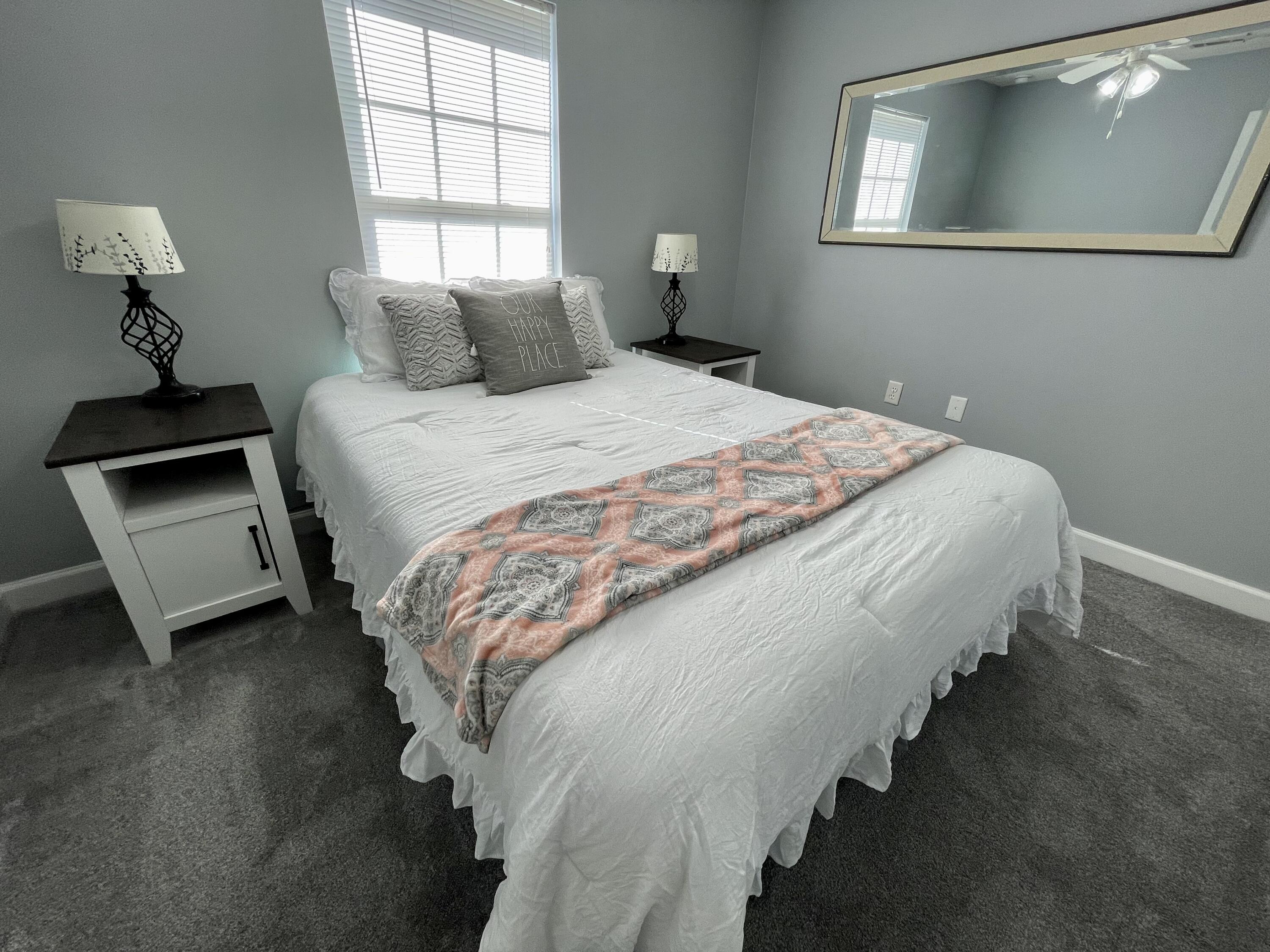 4694 Bobolink Way Crestview, FL 32539 - Photo 13 of 28 a bedroom with bed and window