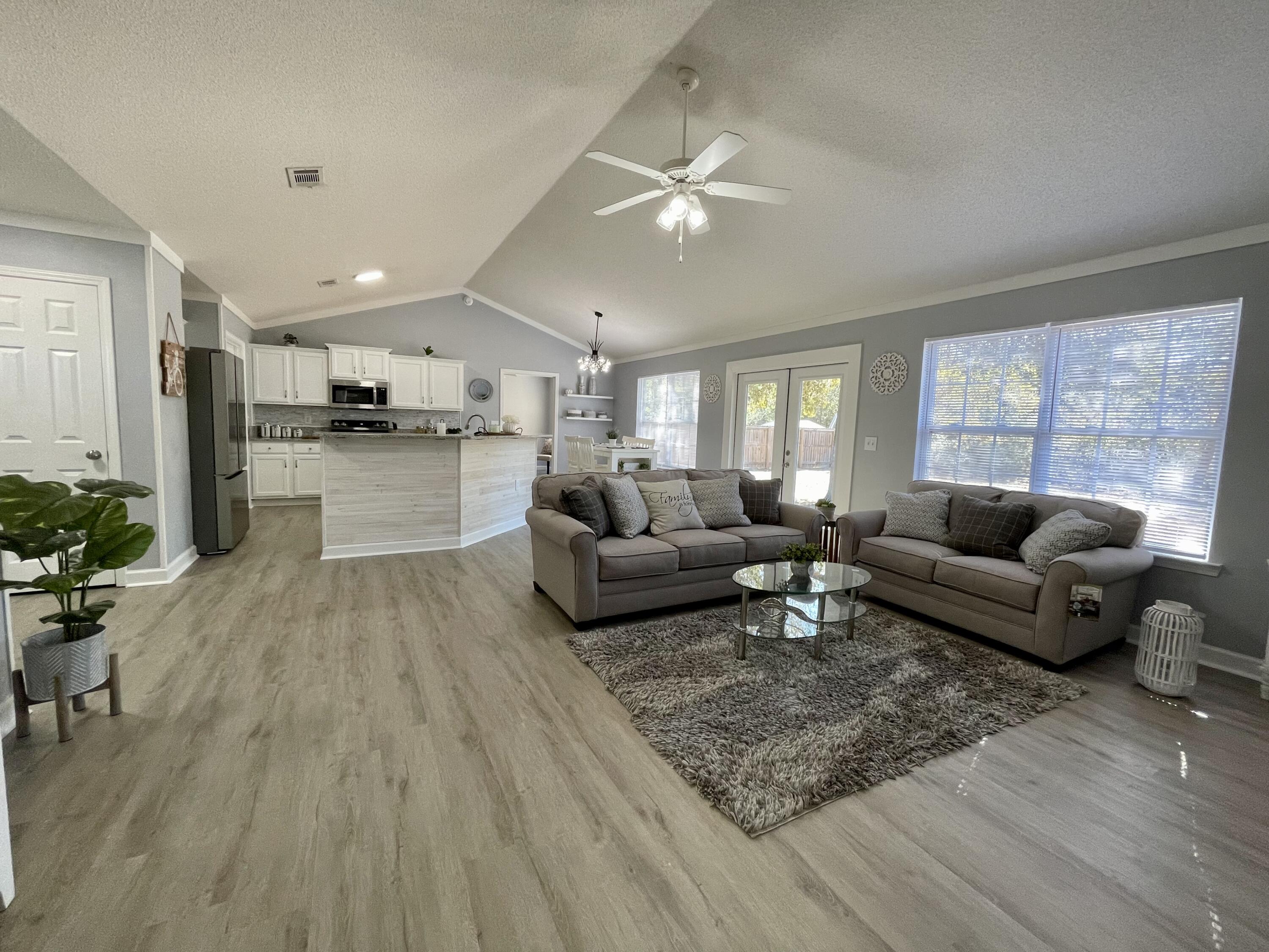 4694 Bobolink Way Crestview, FL 32539 - Photo 14 of 28 a living room with furniture and a wooden floor