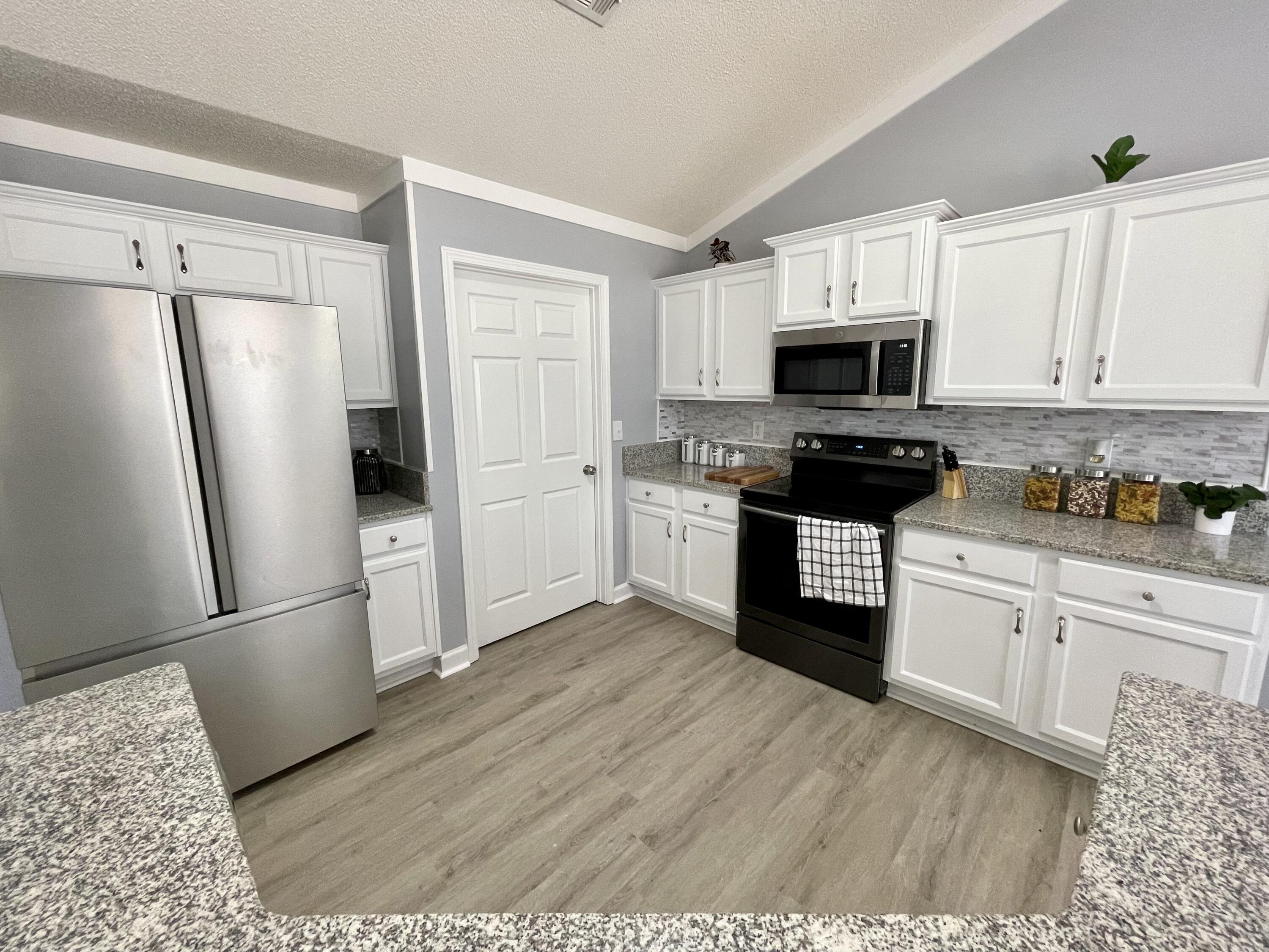 4694 Bobolink Way Crestview, FL 32539 - Photo 15 of 28 a kitchen with stainless steel appliances granite countertop a refrigerator stove a sink and dishwasher