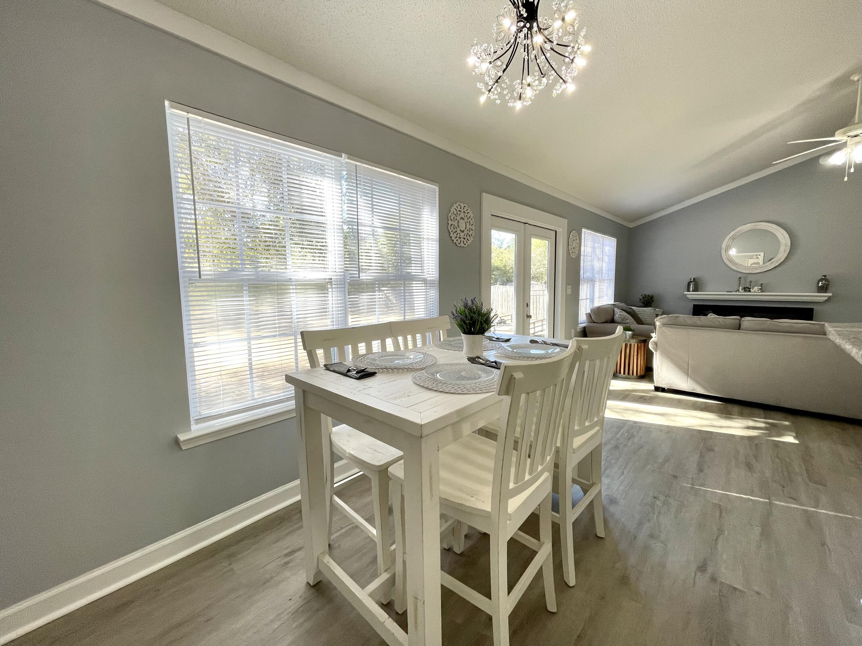 4694 Bobolink Way Crestview, FL 32539 - Photo 18 of 28 a view of a dining room with furniture window and wooden floor