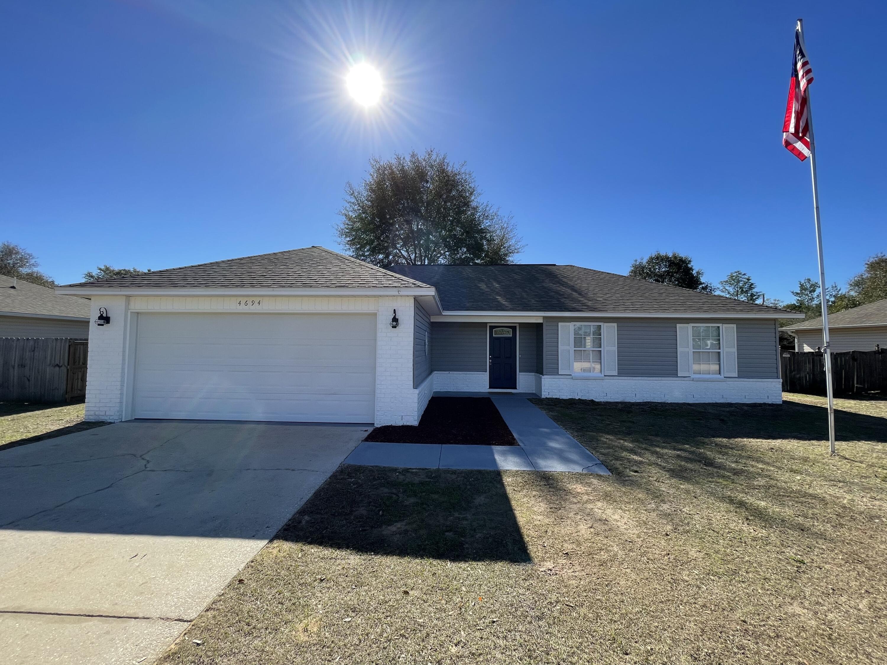 4694 Bobolink Way Crestview, FL 32539 - Photo 2 of 28 a front view of a house with a yard