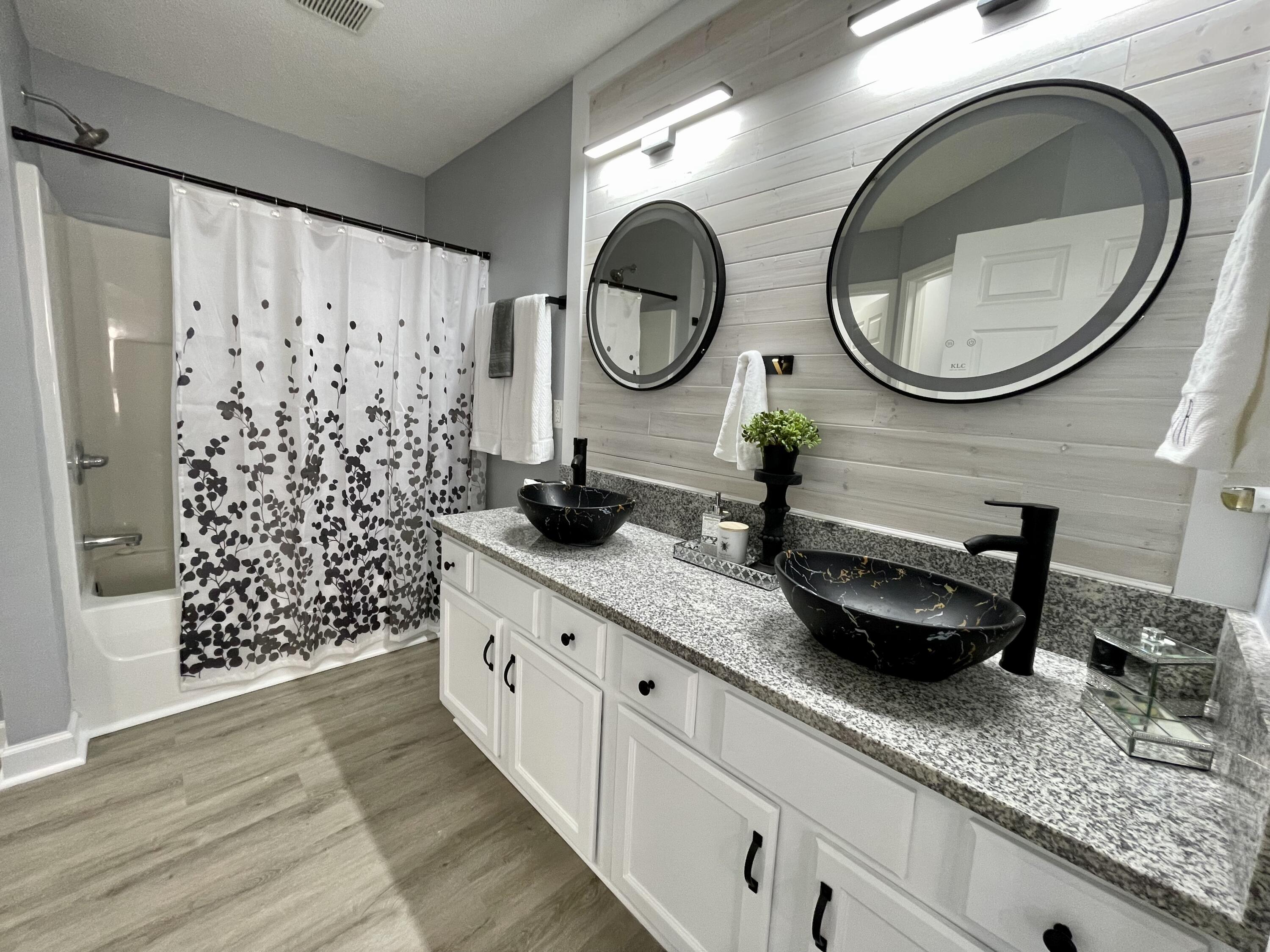4694 Bobolink Way Crestview, FL 32539 - Photo 23 of 28 a bathroom with a granite countertop double vanity sink mirror and shower