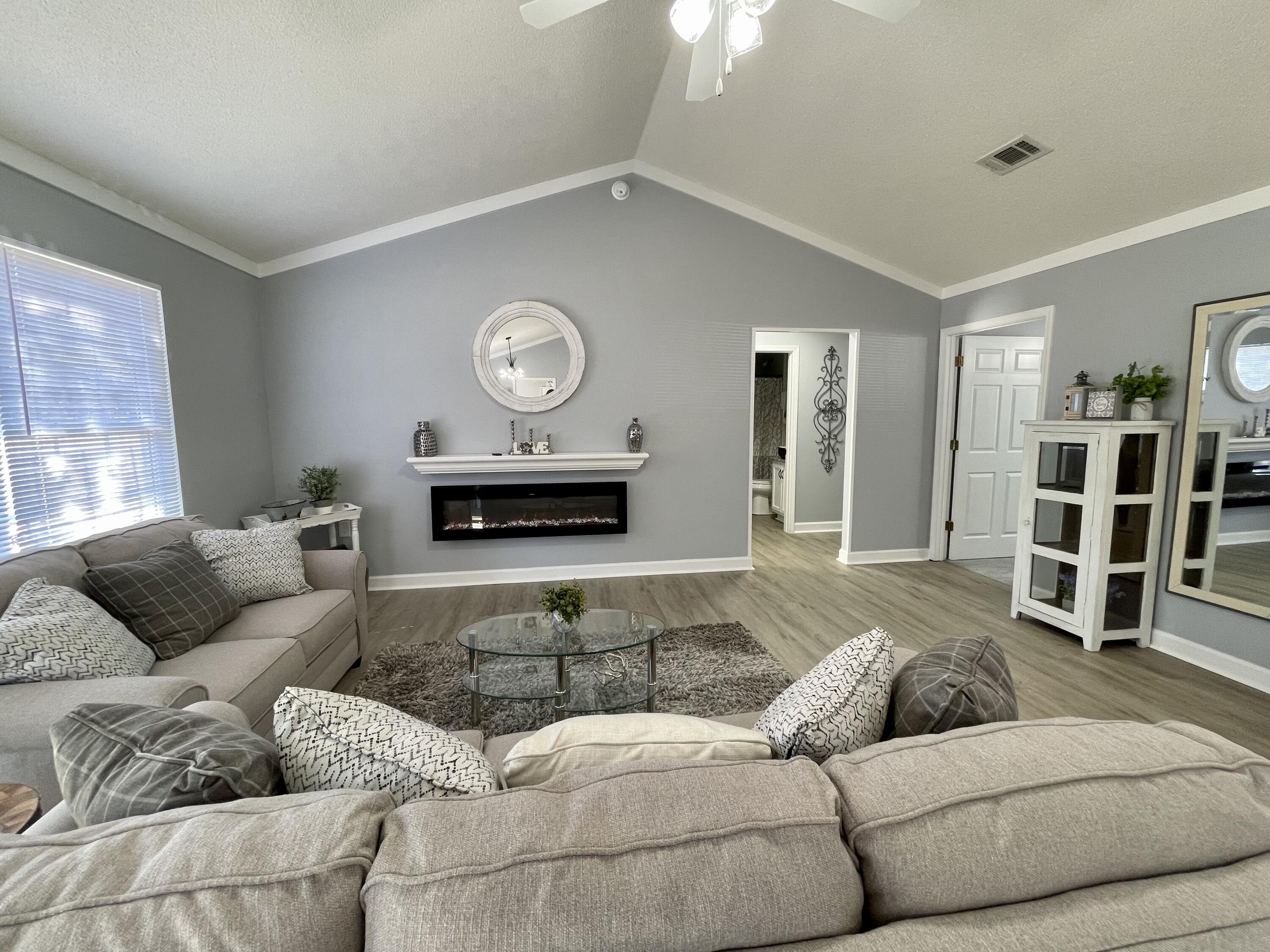 4694 Bobolink Way Crestview, FL 32539 - Photo 26 of 28 a living room with furniture and a fireplace
