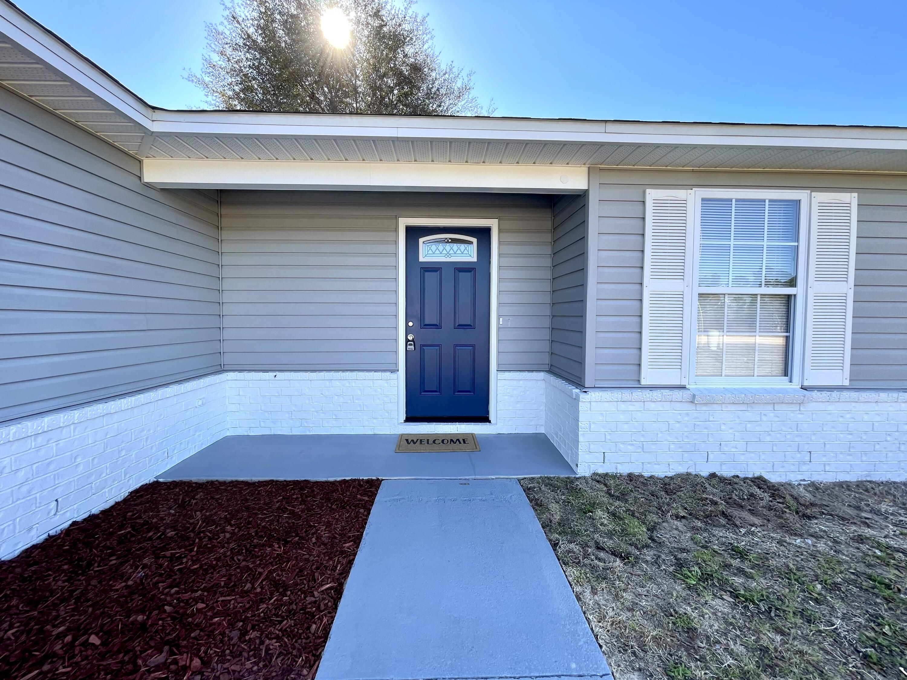 4694 Bobolink Way Crestview, FL 32539 - Photo 27 of 28 a front view of a house with a yard