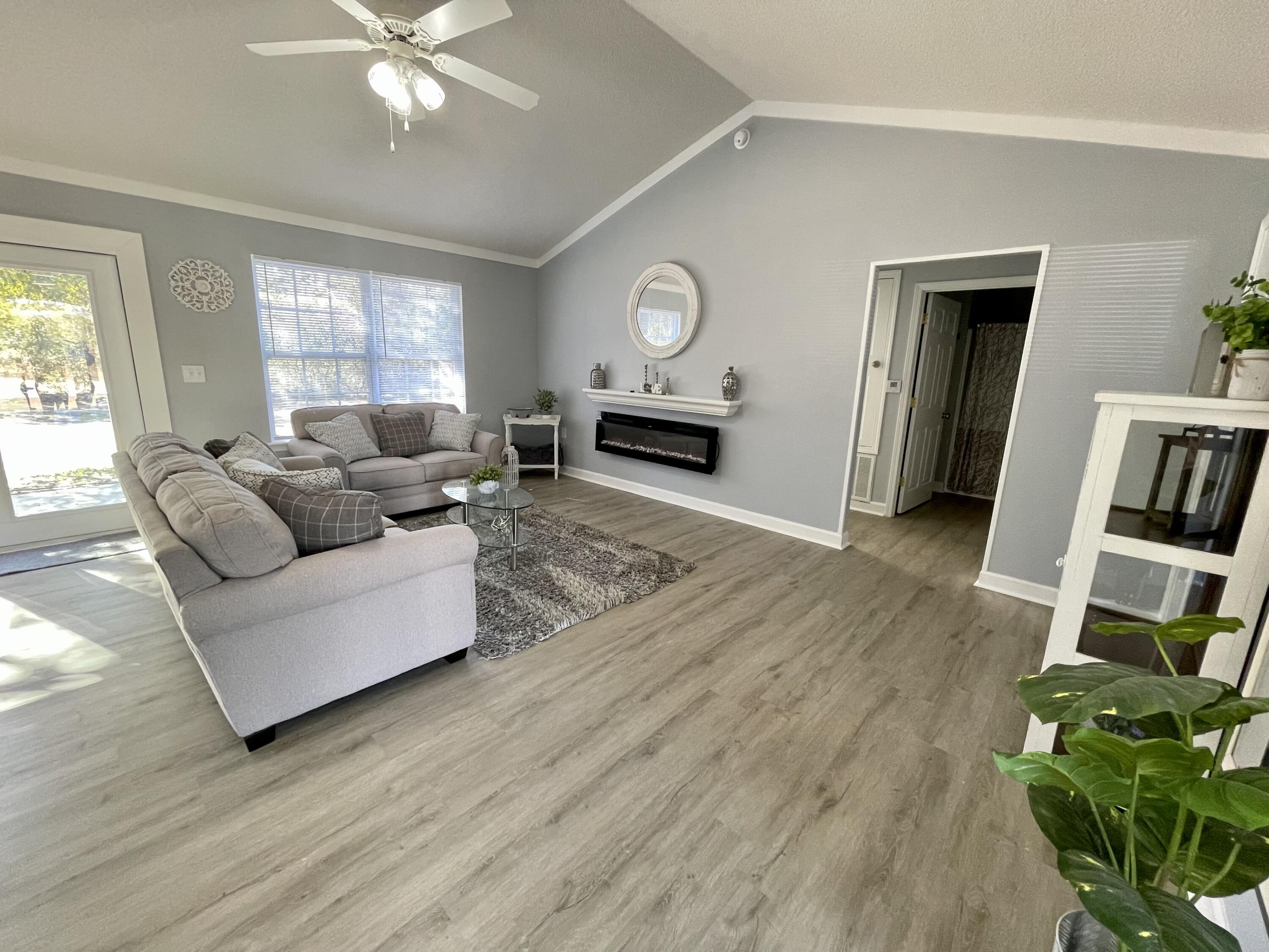 4694 Bobolink Way Crestview, FL 32539 - Photo 6 of 28 a living room with furniture and a window