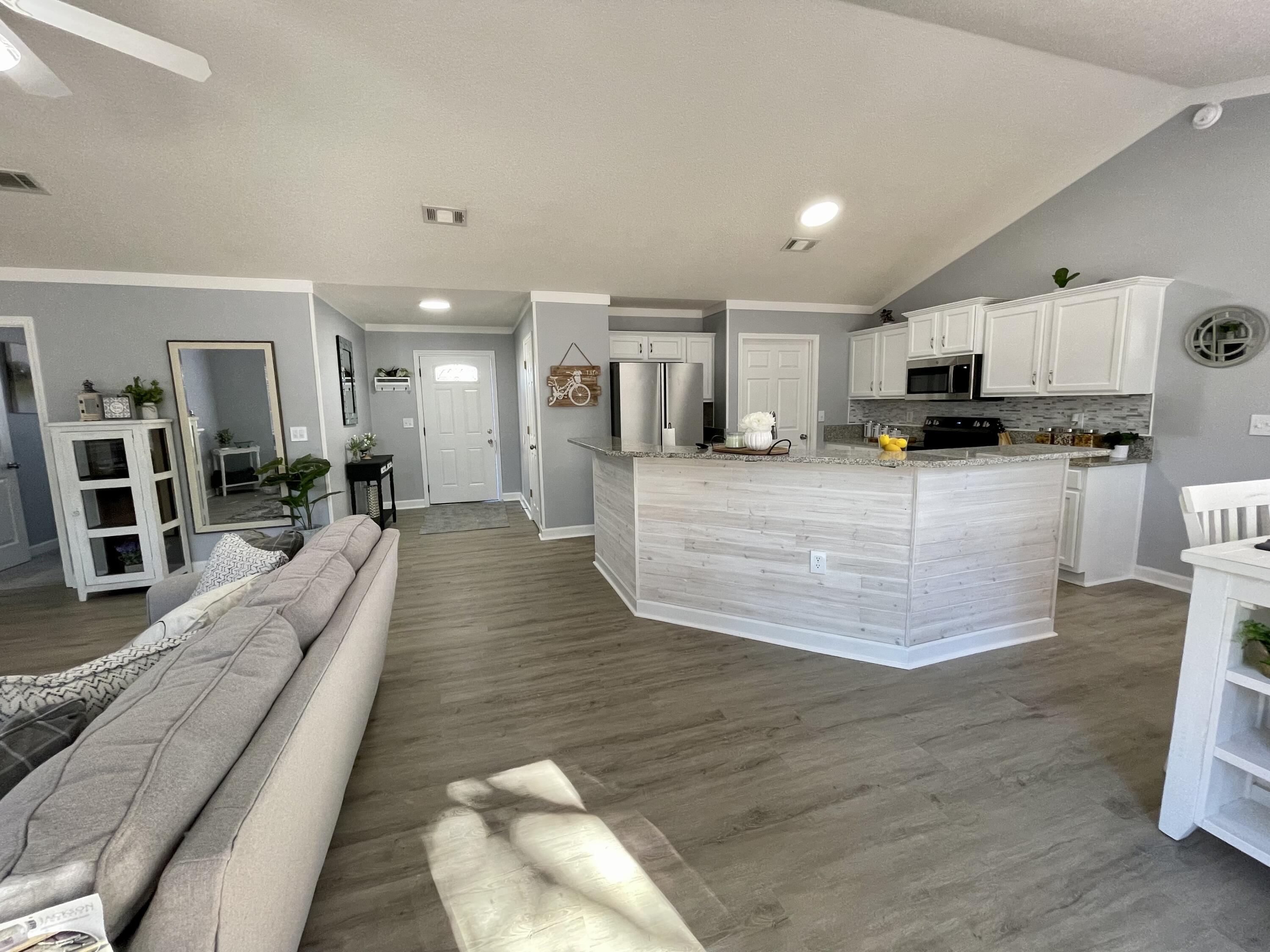 4694 Bobolink Way Crestview, FL 32539 - Photo 8 of 28 a large kitchen with kitchen island lots of counter space a sink and stainless steel appliances