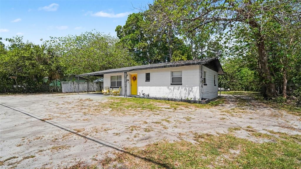 2305 Northeast 35th Street Ocala, FL 34479 - Photo 5 of 26 a backyard of a house with large trees and barbeque oven
