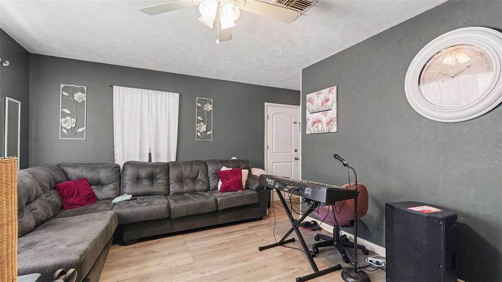 2305 Northeast 35th Street Ocala, FL 34479 - Photo 8 of 26 a living room with furniture and a wooden floor