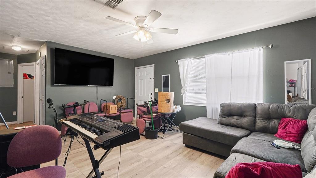 2305 Northeast 35th Street Ocala, FL 34479 - Photo 9 of 26 a living room with furniture and a flat screen tv