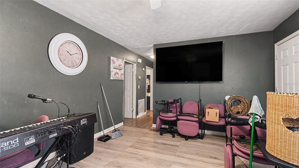 2305 Northeast 35th Street Ocala, FL 34479 - Photo 10 of 26 a living room with furniture and a flat screen tv