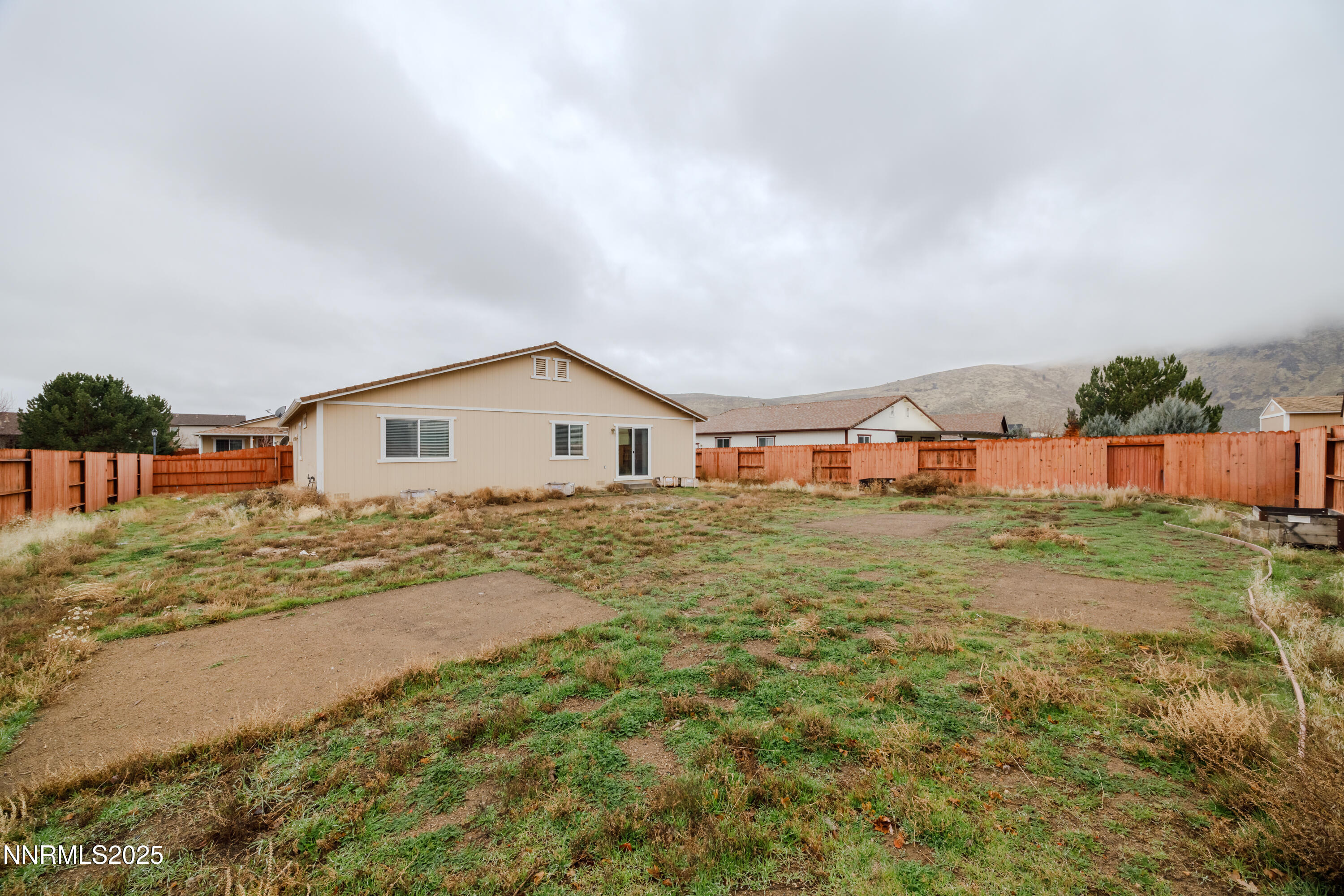 17635 Lake Powell Drive Reno, NV 89508 - Photo 22 of 23 a view of backyard of house with wooden fence