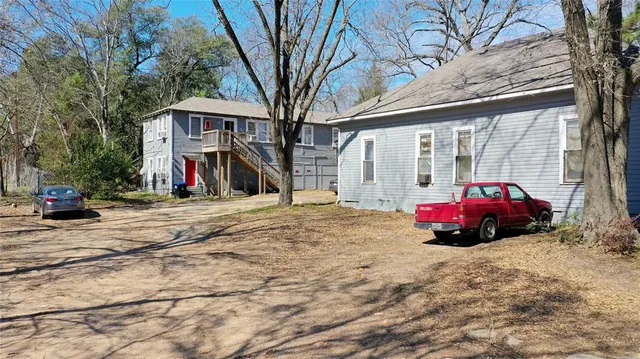 a front view of a house with a tree