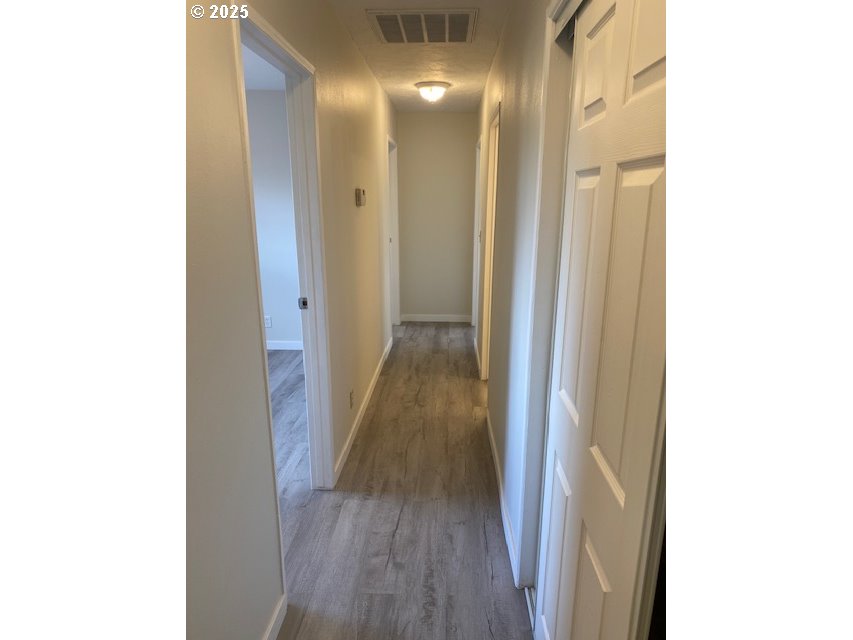 82277 Davisson Road Creswell, OR 97426 - Photo 14 of 48 a view of a hallway with wooden floor