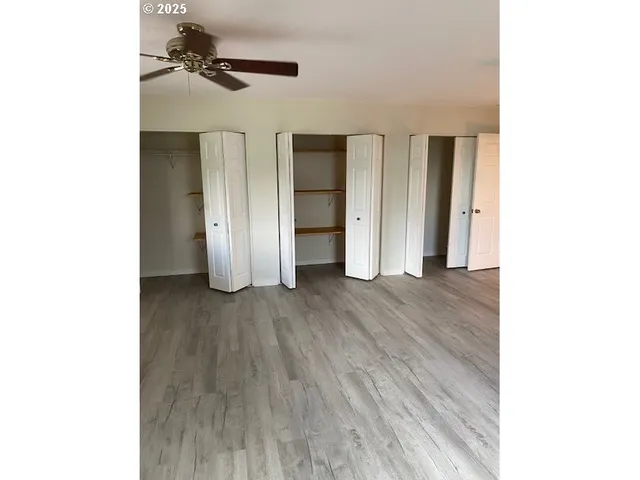 a view of a room with closet and wooden floor