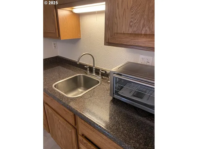 a close view of a sink and a kitchen counter top