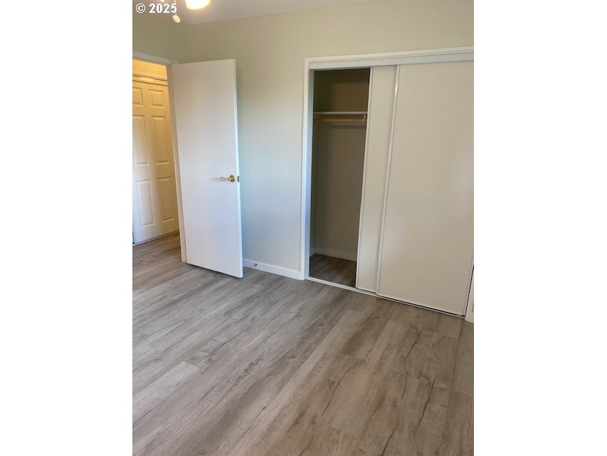 82277 Davisson Road Creswell, OR 97426 - Photo 6 of 48 a view of an empty room with wooden floor