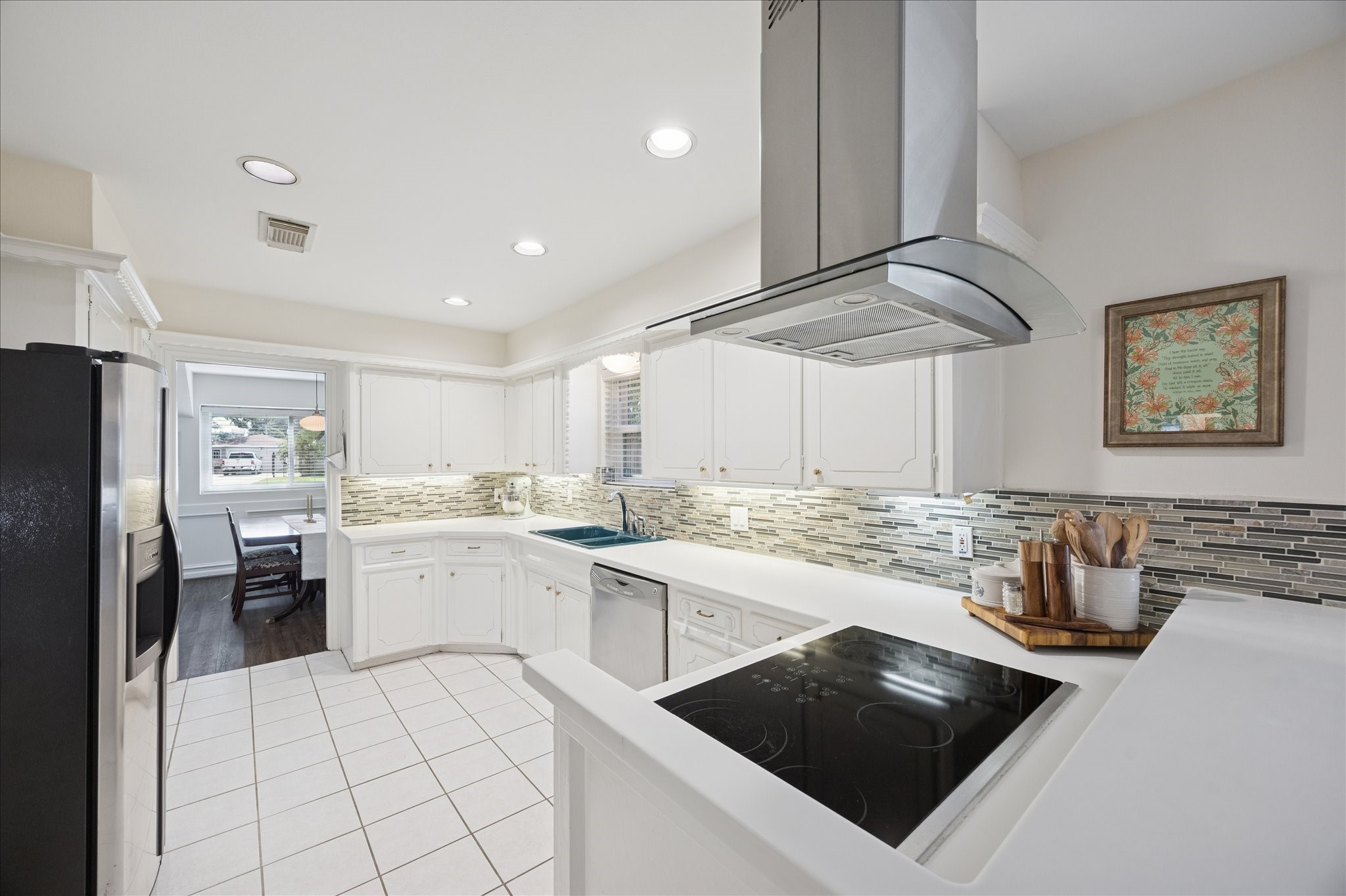 10050 Locke Lane Houston, TX 77042 - Photo 11 of 31 a kitchen with a white cabinets and stove