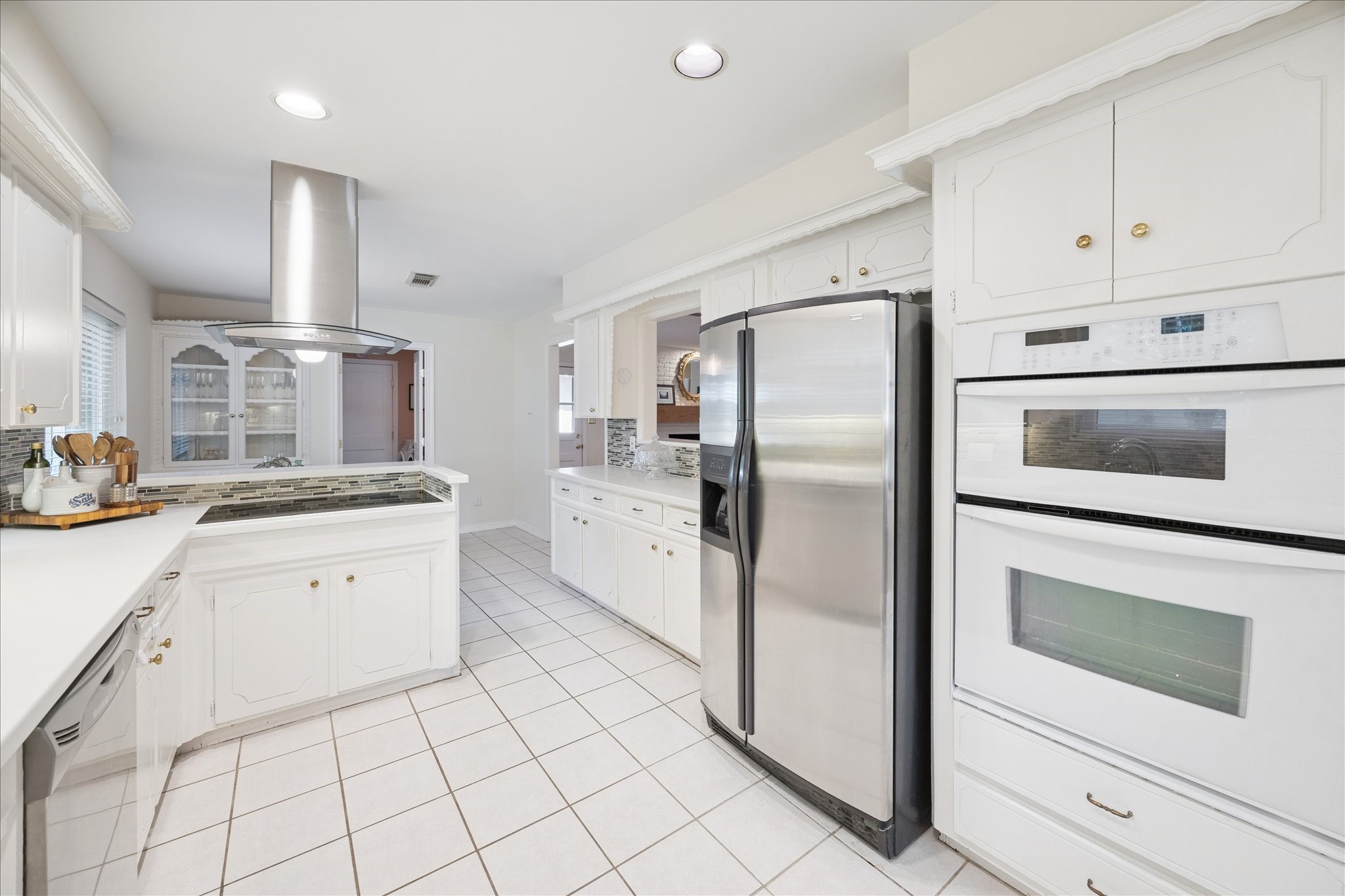 10050 Locke Lane Houston, TX 77042 - Photo 12 of 31 a kitchen with white cabinets stainless steel appliances and sink