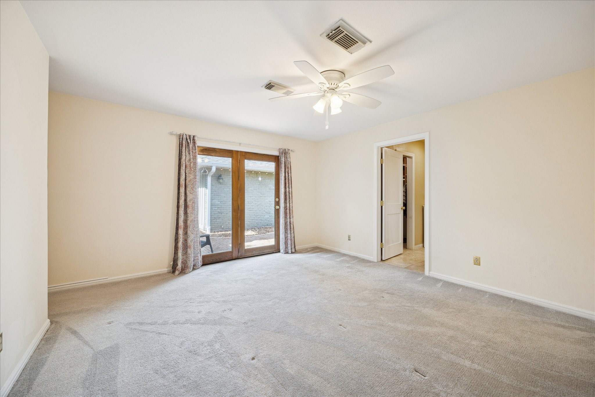 10050 Locke Lane Houston, TX 77042 - Photo 13 of 31 an empty room with windows and fan