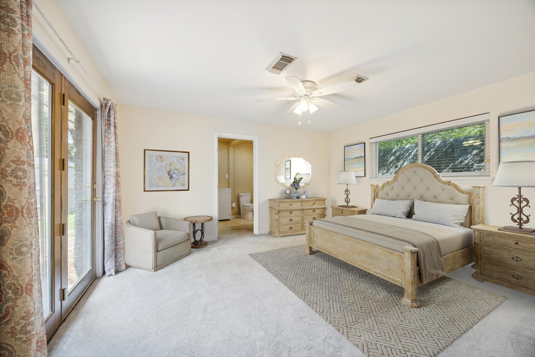 10050 Locke Lane Houston, TX 77042 - Photo 15 of 31 a spacious bedroom with a large bed and a chandelier