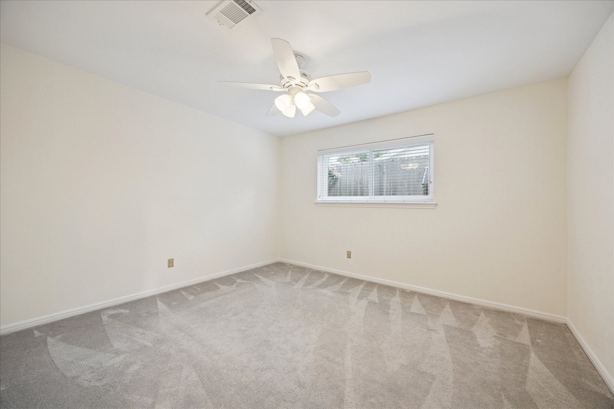 10050 Locke Lane Houston, TX 77042 - Photo 21 of 31 an empty room with a window and a fan