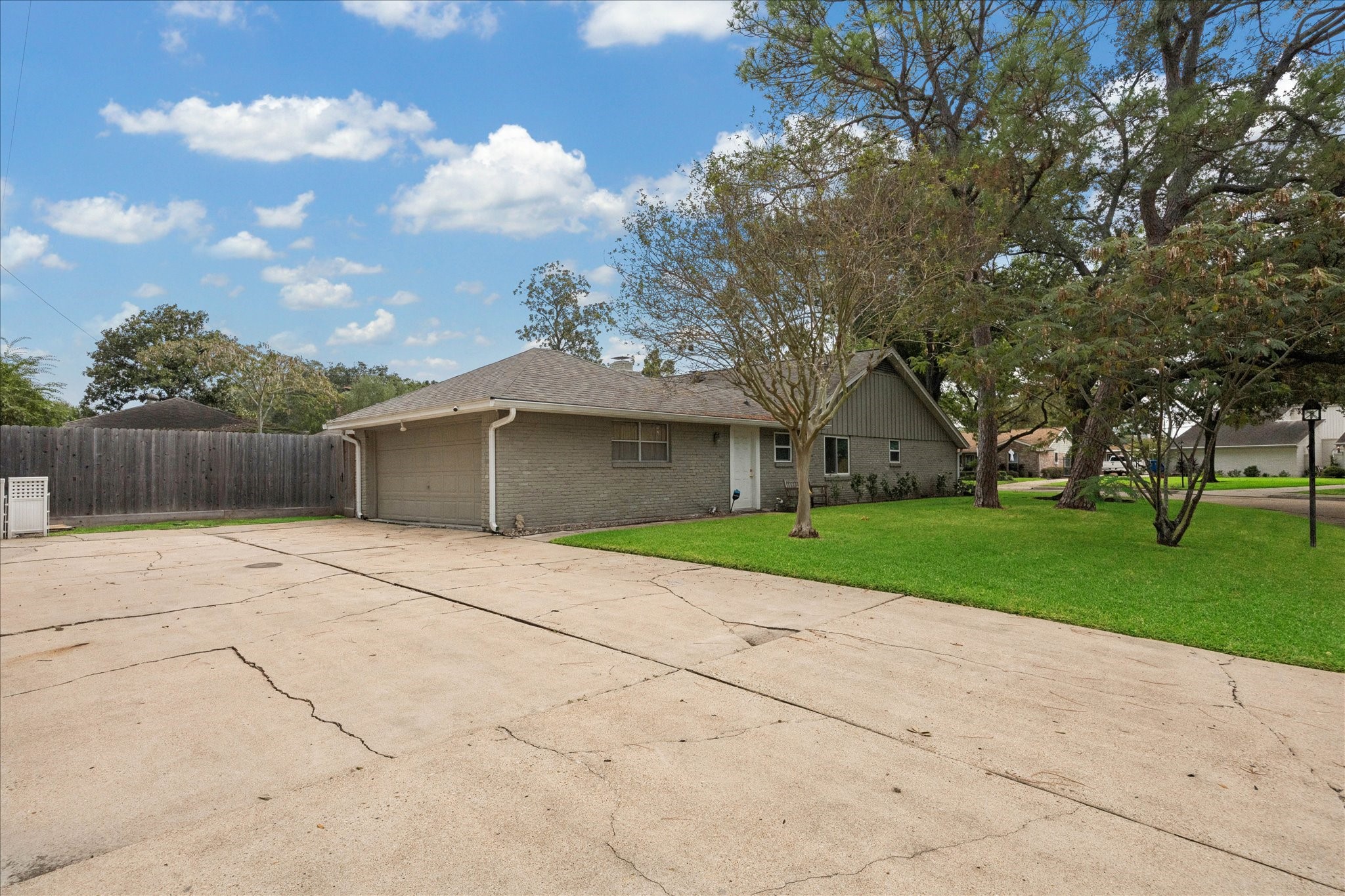 10050 Locke Lane Houston, TX 77042 - Photo 30 of 31 a front view of a house with a yard and garage