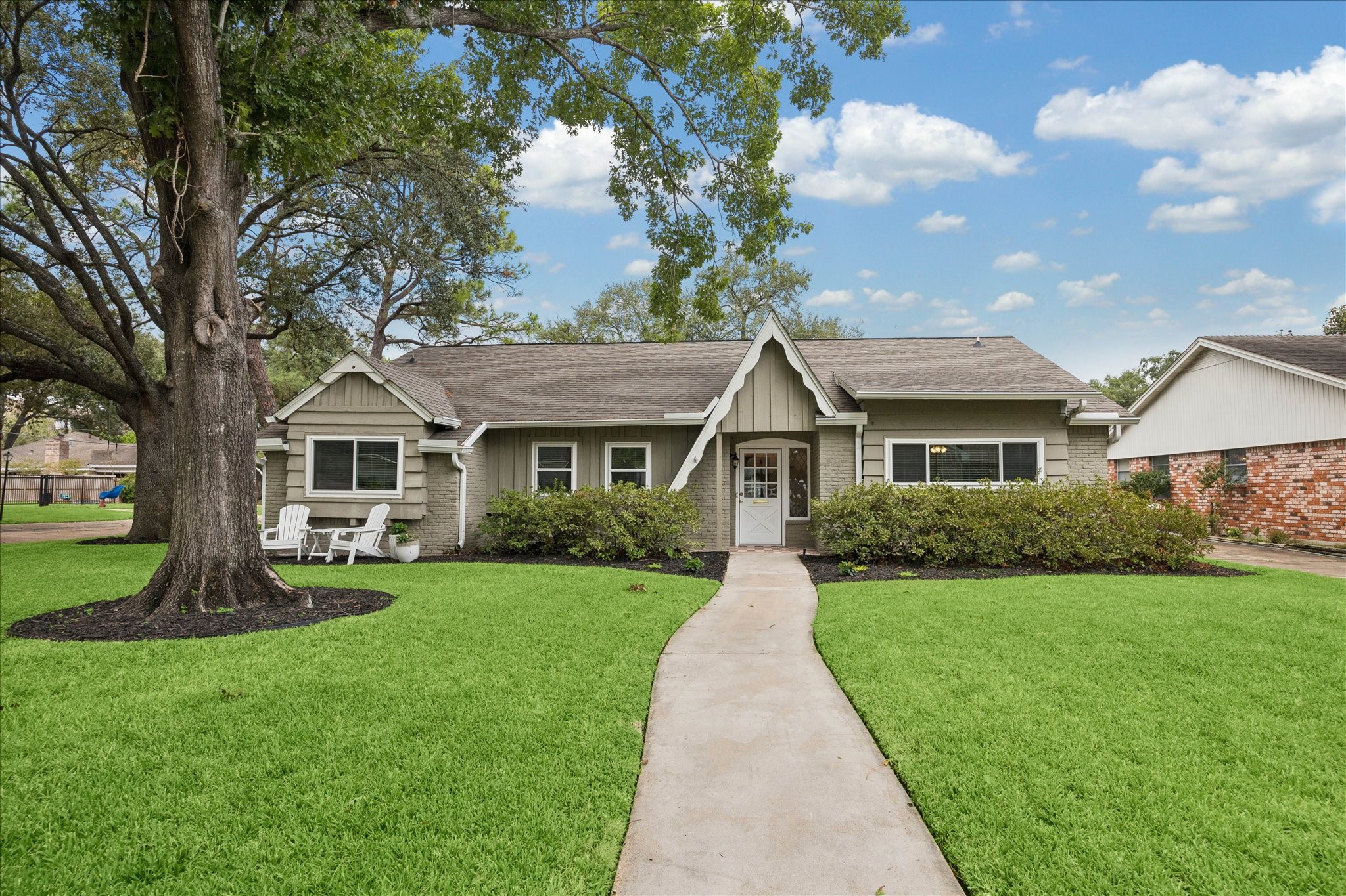 10050 Locke Lane Houston, TX 77042 - Photo 31 of 31 a front view of a house with a yard and porch
