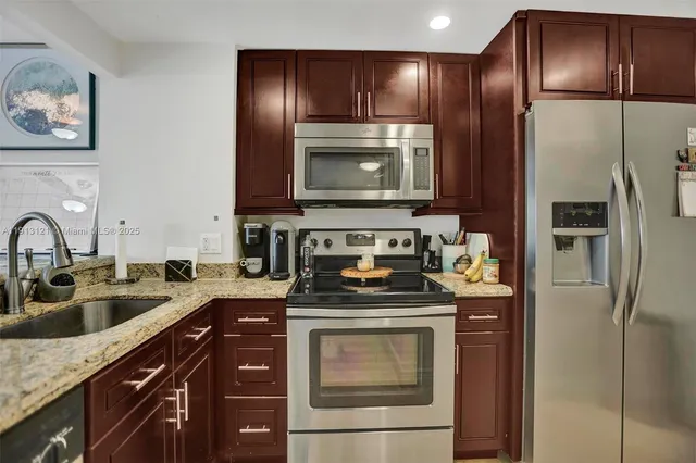 a kitchen with a refrigerator and a sink