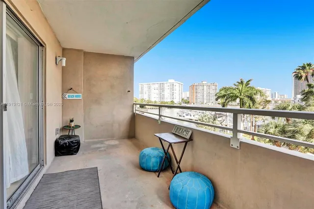 a view of a chairs and table in a balcony